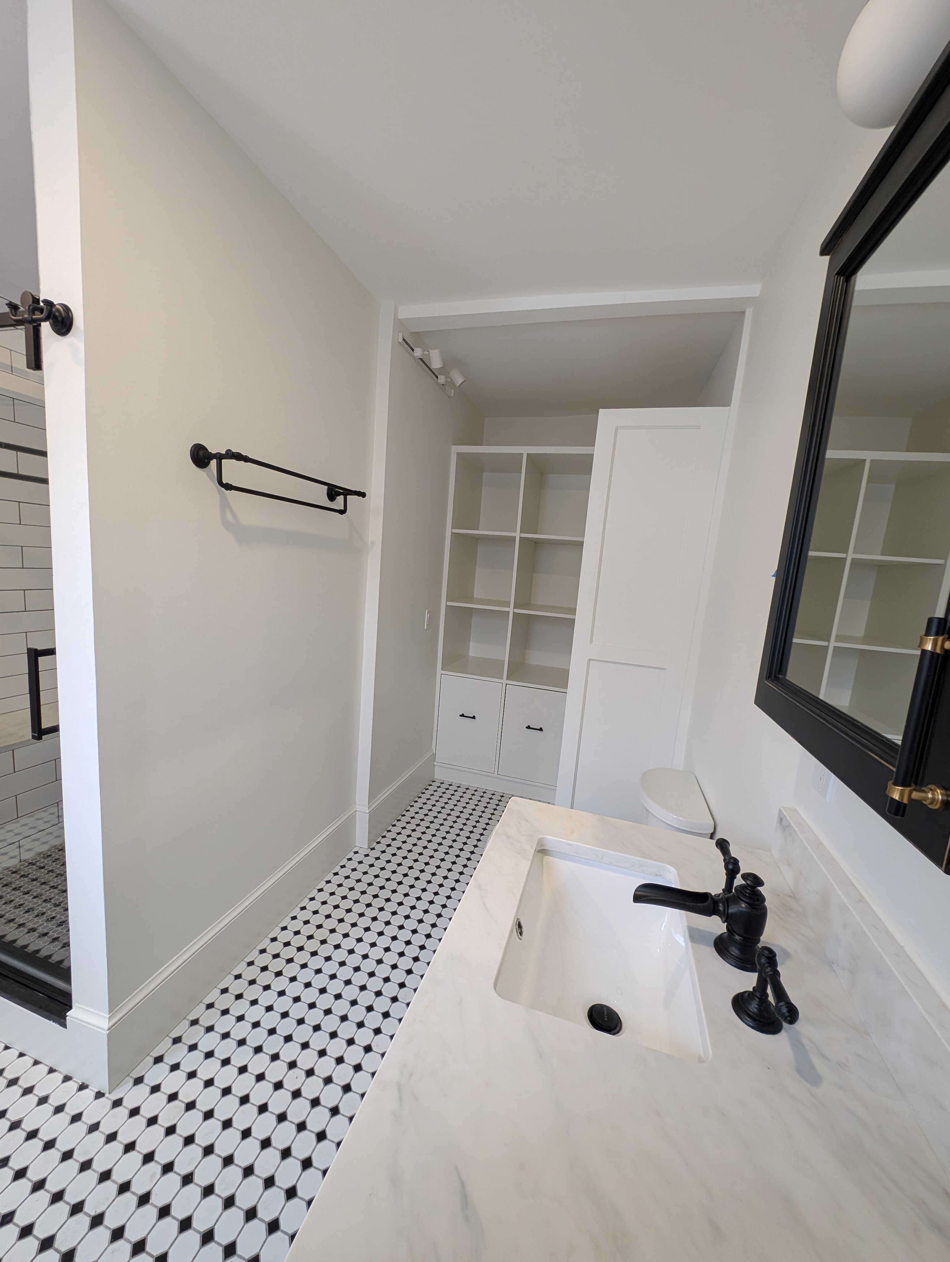 Bathroom vanity with marble top and tile floor by Pro-Tech Contracting